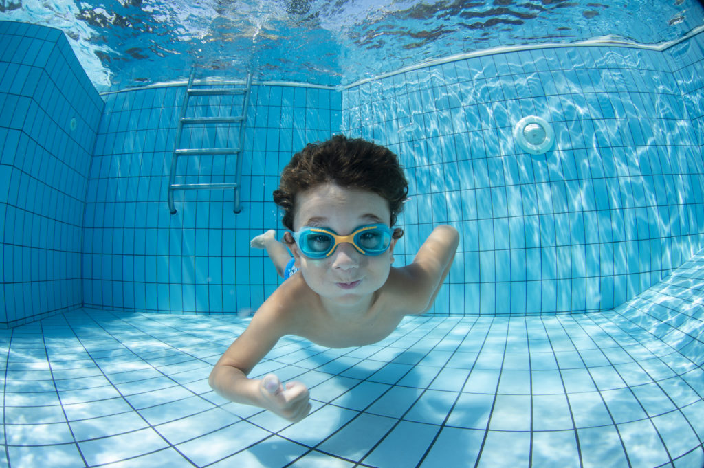 Underwater Young Boy Fun in the Swimming Pool with Goggles